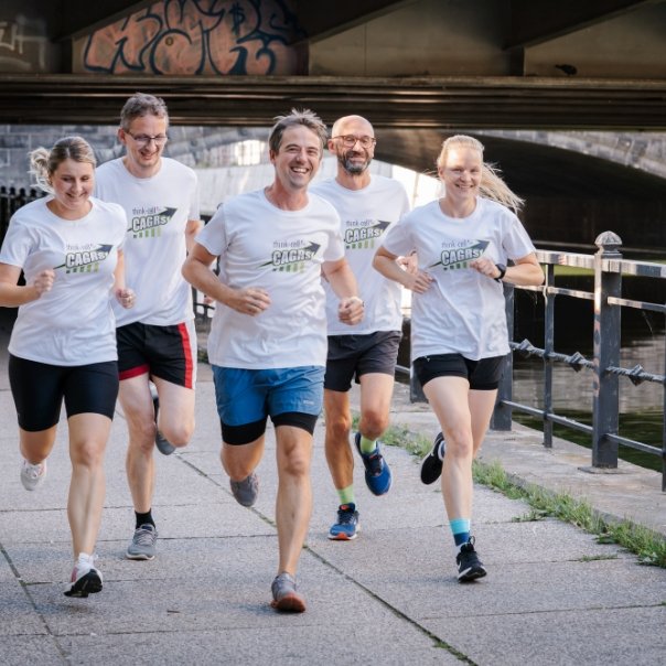 Smiling members of think-cell running group going out for a run.