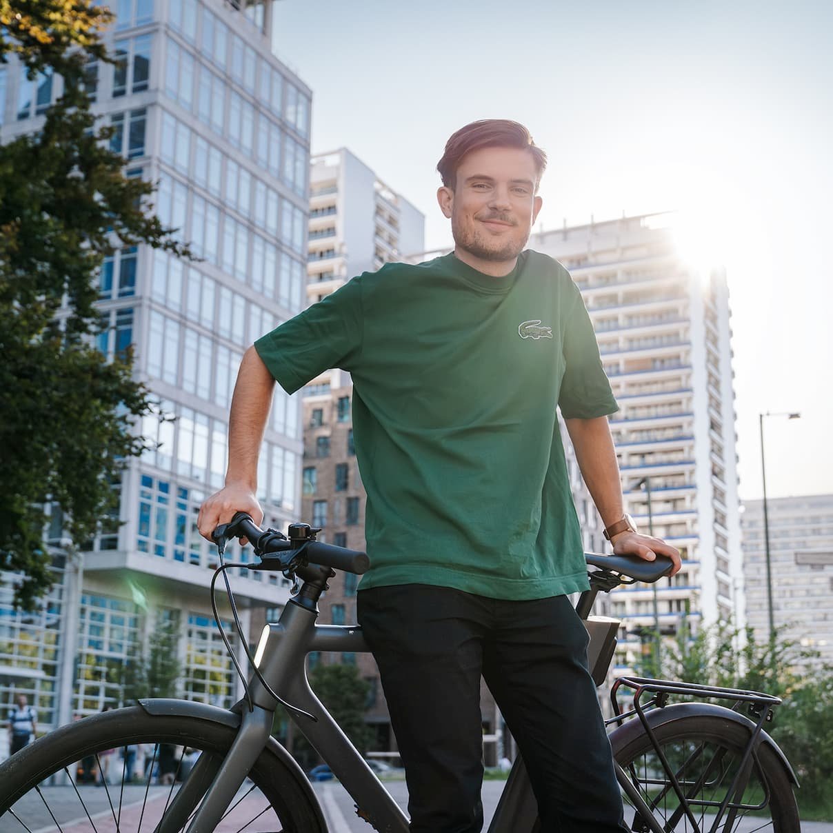 Man with his bike in front of office building.